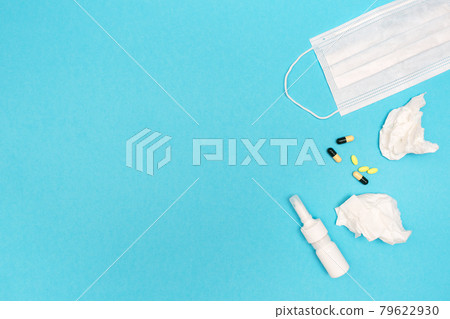 Seasonal spring allergy. Flat lay with nasal spray, pills, used wipes, and medical mask. Catch a cold. Template for text 79622930