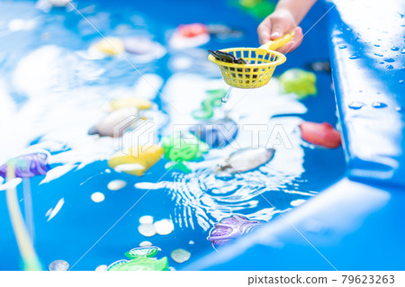 Child Fisher Catching Plastic Toy Fish On Pool Amusement Park Summer Day 79623263