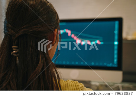 Woman working on stock market on digital tablet 79628887