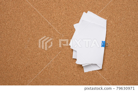 white blank paper sheets bound with a clip on brown background white blank paper sheets bound with a clip on brown background 79630971