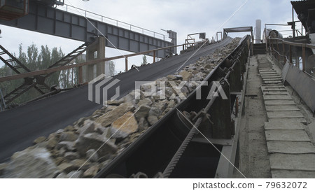 Conveyor belt with gravel on mining site 79632072