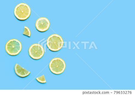 Fresh lemon slices on blue background. 79633276