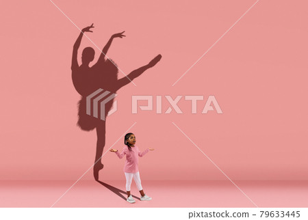 Childhood and dream about big and famous future. Conceptual image with girl and shadow of female ballet dancer on coral pink wall, background. 79633445