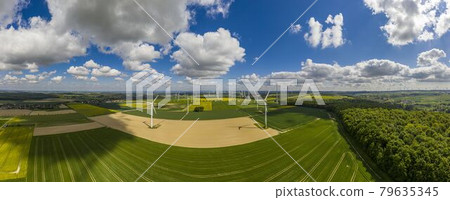 Panoramic aerial view over giant wind power field in Germany during daytime 79635345