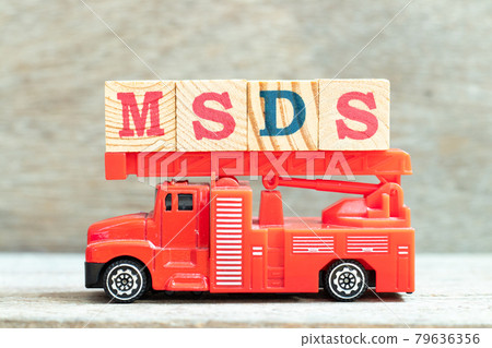 Fire ladder truck hold letter block in word MSDS (Abbreviation of material safety data sheet) on wood background 79636356