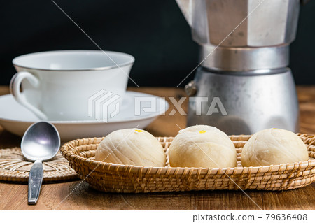 View of homemade chinese pastry or moon cake filled with sweet mung bean paste and salted egg yolk. View of homemade chinese pastry or moon cake filled with sweet mung bean paste and salted egg yolk. 79636408