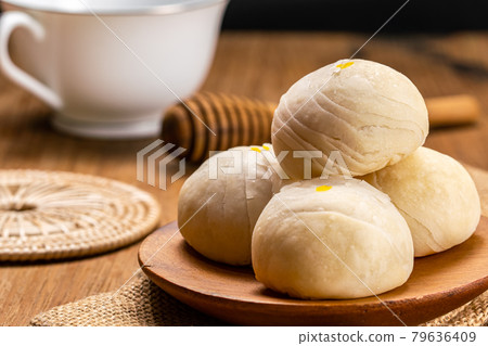 Closeup view of homemade chinese pastry or moon cake filled with sweet mung bean paste and salted egg yolk. 79636409