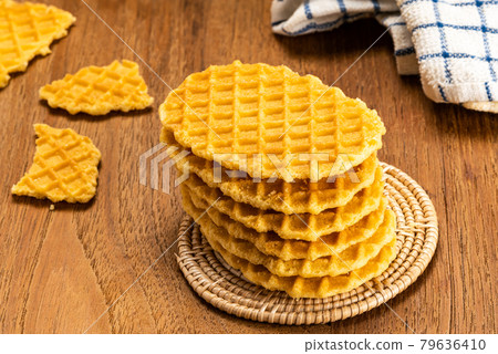 High angle view stack of homemade crispy waffles on bamboo mat. High angle view stack of homemade crispy waffles on bamboo mat. 79636410