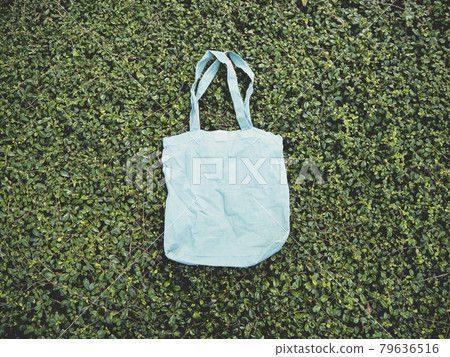 Blank blue Mockup Linen Cotton Tote Bag on Green Bush Trees Foliage Background. Eco Nature Friendly Style. Environmental Conservation Recycling Concept. Template for Artwork Text. Japanese Blank blue Mockup Linen Cotton Tote Bag on Green Bush Trees Foliage Background. Eco Nature Friendly Style. Environmental Conservation Recycling Concept. Template for Artwork Text. Japanese 79636516