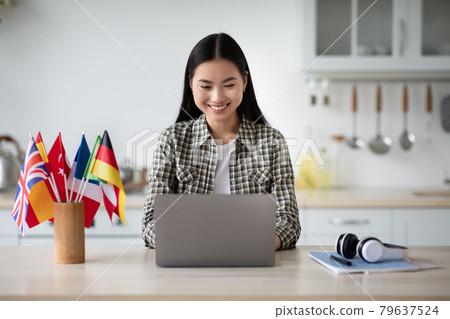 Cheerful asian woman student looking for online course Cheerful asian woman student looking for online course 79637524