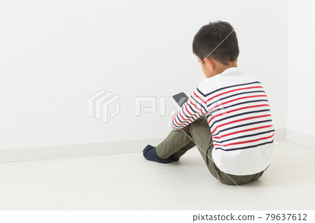 A child touching a smartphone A child touching a smartphone 79637612
