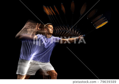 Portrait of young man, male badminton player, shuttler in motion and action on dark background. Stroboscope effect. 79639389