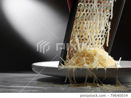Grated cheese and grater. 79640034