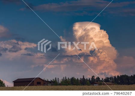 Extreme thunderstorm clouds moving over fields, climate change concept 79640267