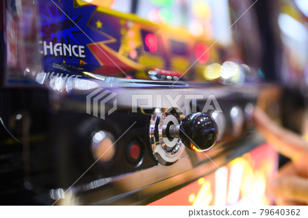 Hands playing pachinko slots (out focus) Hands playing pachinko slots (out focus) 79640362