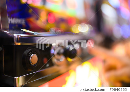 Hands playing pachinko slots (out focus) Hands playing pachinko slots (out focus) 79640363