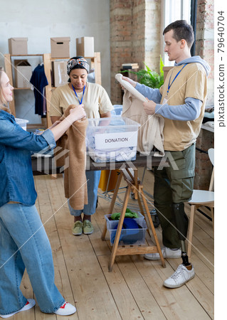 Group of people choosing donation clothes Group of people choosing donation clothes 79640704