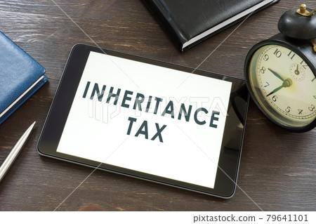 Inheritance tax words on the tablet and notepad. 79641101
