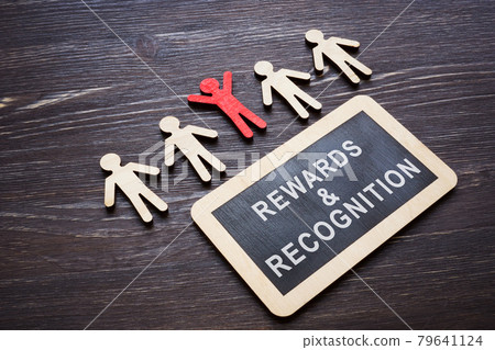 Plate with Rewards and recognition words and wooden employee figures. 79641124