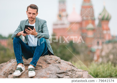 Happy young urban man in european city. Happy young urban man in european city. 79641574