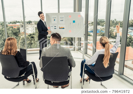 Businesswomen and businessmen in group meeting. 79641972