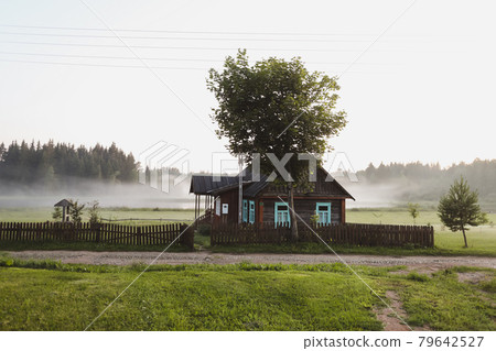 wooden european house in a picturesque countryside at sunset in summer wooden european house in a picturesque countryside at sunset in summer 79642527