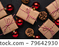 Christmas holidays composition. Gift boxes, red ornament and bauble decorations with pine cones 79642930