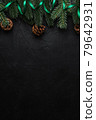 Christmas holidays composition. Green ribbon, fir-tree and pine cones. Copy space 79642931