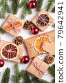 Christmas holidays zero waste paper gifts wrapping with tag, baubles, dried fruit and fir branches 79642941