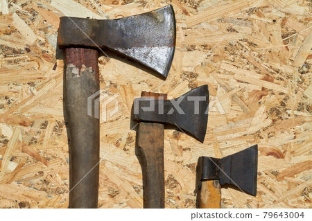 Set of work axes with wooden handle on plywood backgroud. Set of work axes with wooden handle on plywood backgroud. 79643004