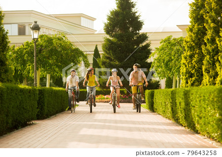 Friends are relaxing by cycling together. Friends are relaxing by cycling together. 79643258
