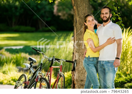 Couple with bicycles in the park. Couple with bicycles in the park. 79643265