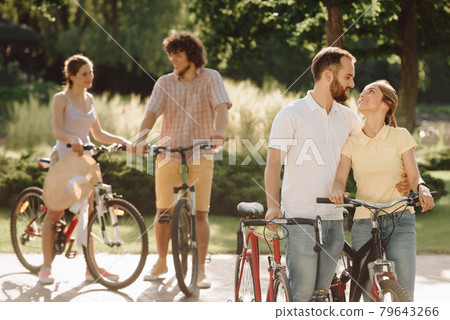 Young loving with bicycles outdoors. Young loving with bicycles outdoors. 79643266