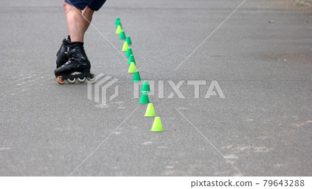 Boy rollerblading on asphalt road. Boy rollerblading on asphalt road. 79643288