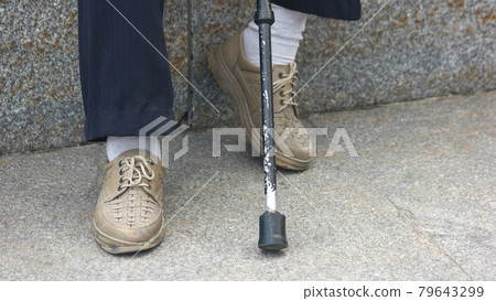 Old man sitting with walking stick. Old man sitting with walking stick. 79643299