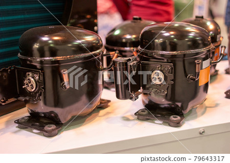Close up black refrigerator compressors. 79643317
