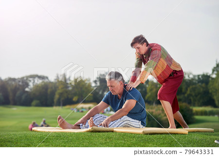 Touching shoulders, doing thai massage. Touching shoulders, doing thai massage. 79643331