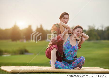 Thai massage yoga on the grass. 79643347