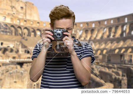 Tourist boy using camera outdoor. Tourist boy using camera outdoor. 79644053