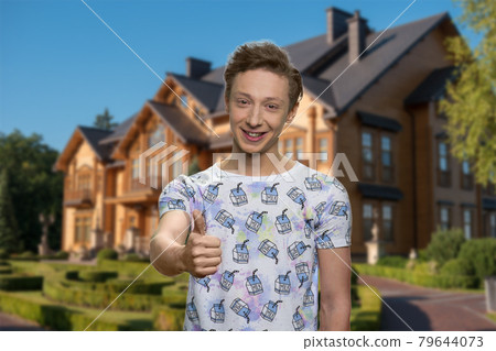 Happy boy giving thumb up outdoor. Happy boy giving thumb up outdoor. 79644073