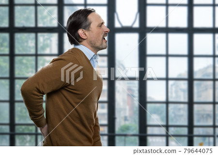 Mature caucasian man suffering from backache. 79644075