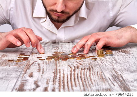 Pile of coins on the wooden table. Pile of coins on the wooden table. 79644235