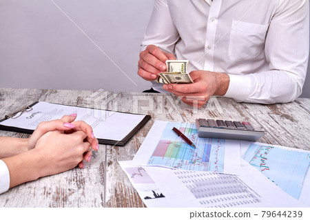 Businessman's counting money after having a deal. Businessman's counting money after having a deal. 79644239