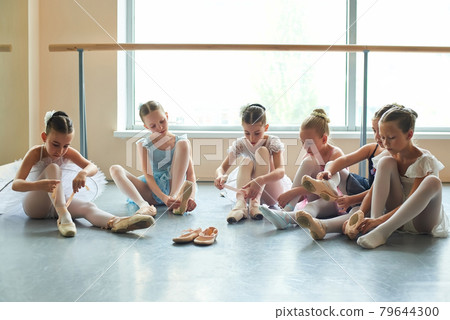 Group of young ballerinas preparing for performance. Group of young ballerinas preparing for performance. 79644300