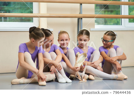 Young ballerina with new ballet slippers. Young ballerina with new ballet slippers. 79644436