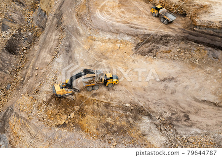 Aerial view of excavators digging ground. Opencast mining quarry. 79644787