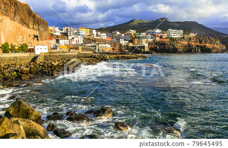 Scenery of Gran Canaria - Puerto de Sardina coastal town over sunset. Canary islands Scenery of Gran Canaria - Puerto de Sardina coastal town over sunset. Canary islands 79645495