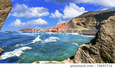 Unique nature of Lanzarote. Black sandy beach with colorful rocks El Golfo. Canary islands Unique nature of Lanzarote. Black sandy beach with colorful rocks El Golfo. Canary islands 79645718