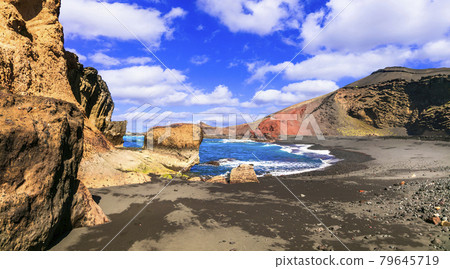 Unique nature of Lanzarote. Black sandy beach with colorful rocks El Golfo. Canary islands Unique nature of Lanzarote. Black sandy beach with colorful rocks El Golfo. Canary islands 79645719