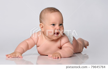6 month old baby infant lies in one diaper on a 6 month old baby infant lies in one diaper on a 79645764